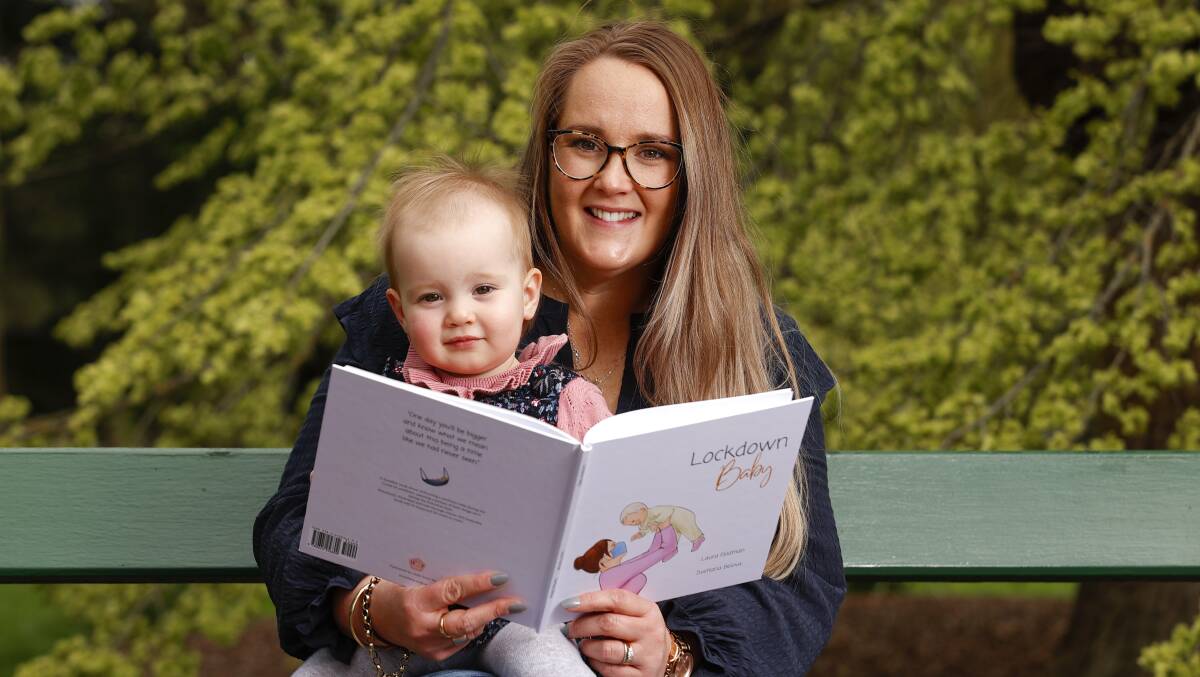 Ballarat's Laura Feldman reads her new book, Lockdown Baby, to daughter Winnie. Photo: Luke Hermer. 
