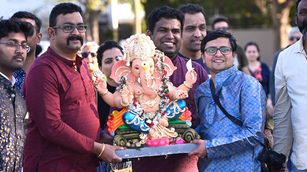 Prem Anand, Gobi Anand and Harisankar Parippaayillam carry the statue during the procession to the Ganesha Visarjan at the festival. Picture by Adam Trafford. 