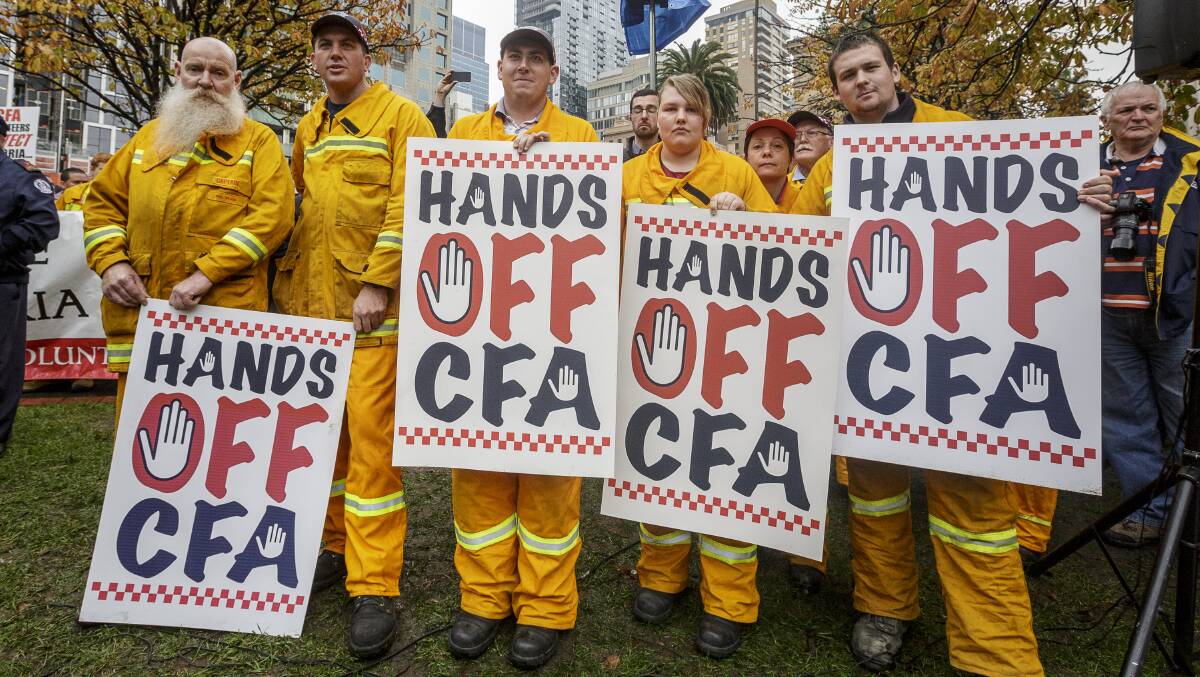CFA volunteers with Liberal Party signs in Melbourne earlier in July. PICTURE: Daniel Pockett 