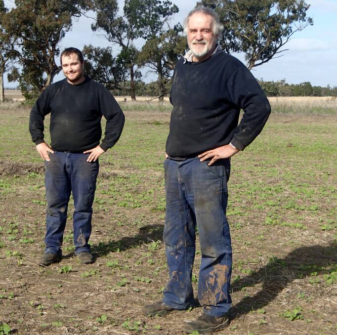 Glenlee farmers Adam and Greg Schwedes in a paddock of newly emerged Bonito canola, sown mid-May. 