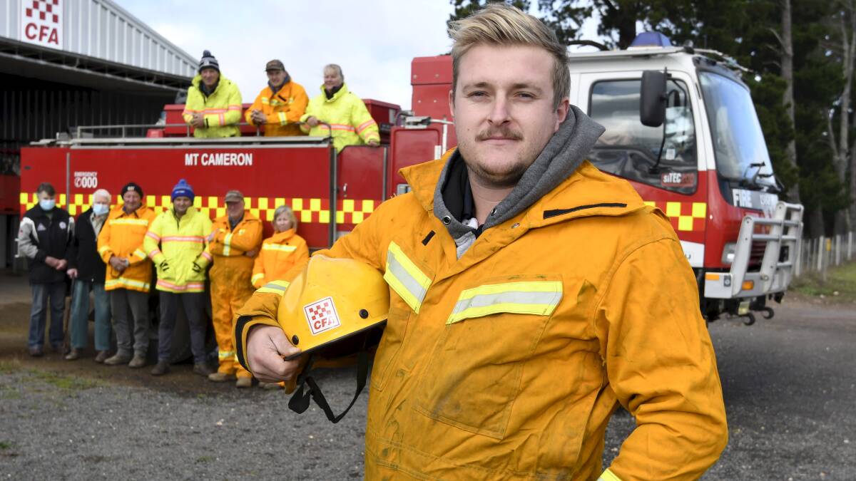 STANDING UP: Firefighter Jake Seers supported by his Mount Cameron Fire Brigade peers Judith and Mae Fawcett, Chris and Ben Hull, Dennis and Rachel Brooks, and Mal Hull, Parker Fawcett and Jo Bedwell (top). Photo by Lachlan Bence.