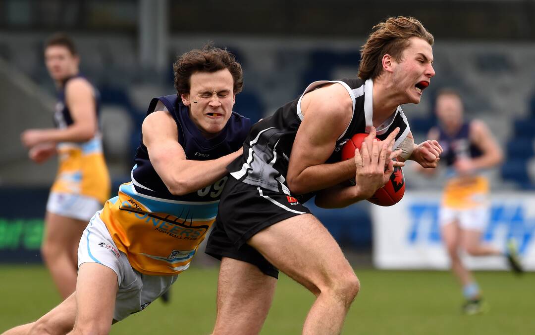 ON THE CHEST: Nicholas Caris of the Rebels marks the ball ahead of Riley Clarke of Bendigo. 