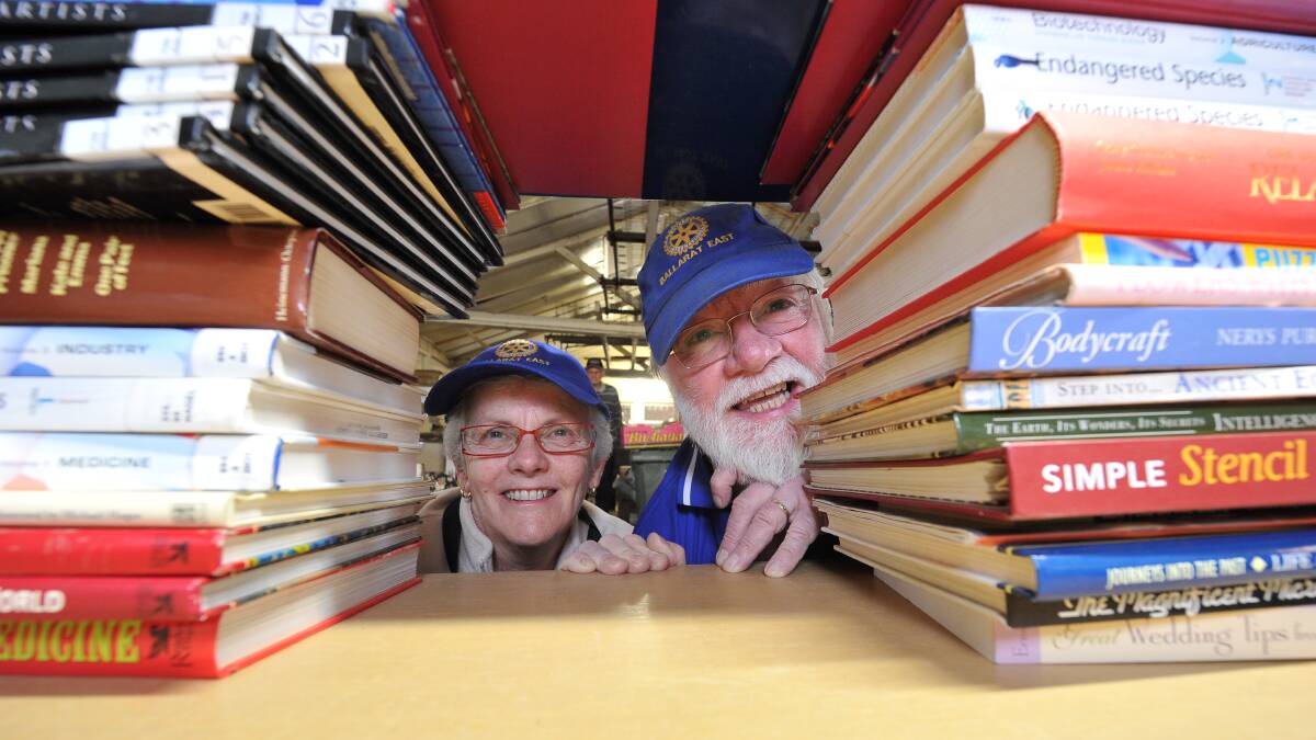 Literary gems: Rotary Club of Ballarat East's Betty Ferris and Jeff Miller get stacking for this weekend's bonanza. Picture: Lachlan Bence