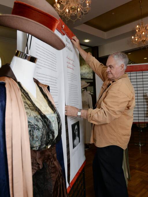 Moving stories: Keith Baverstock setting up the exhibition, which describes powerful stories of Australian women from WWI. Picture: Kate Healy