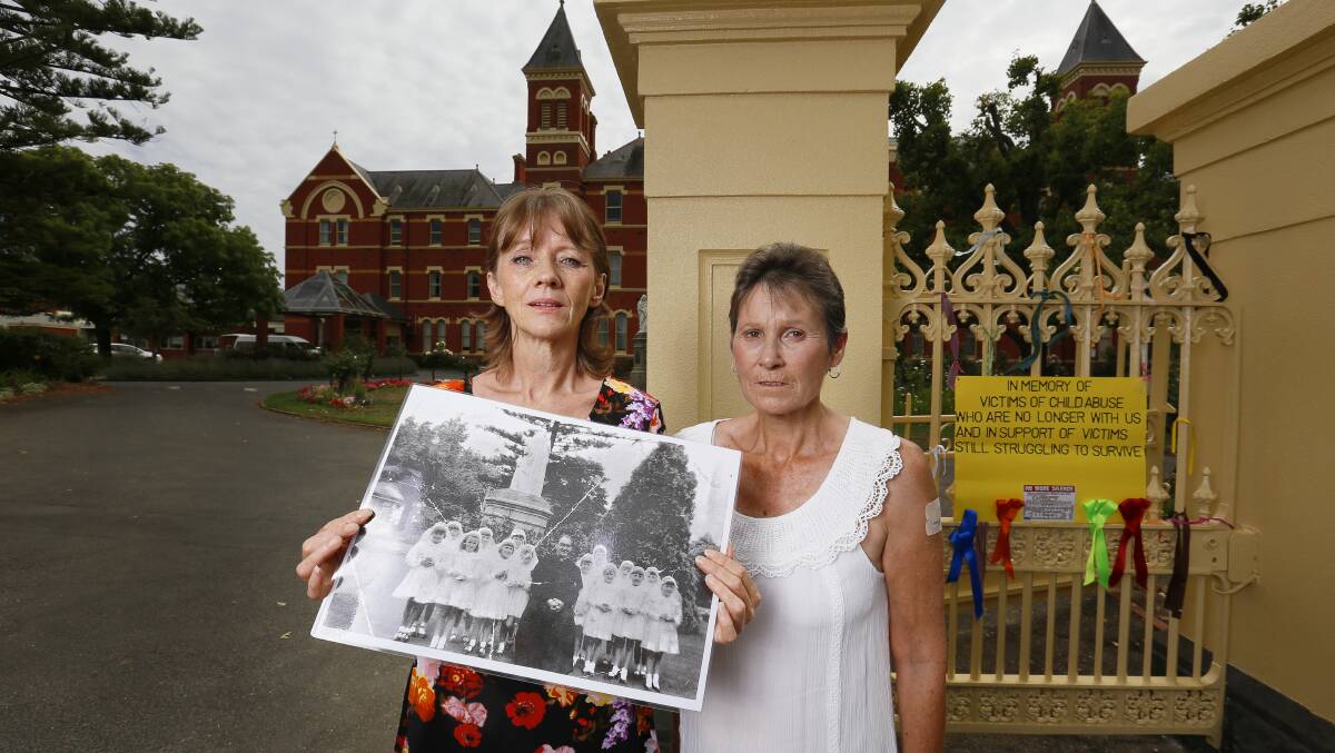 Gabby Short and Wendy Eldridge with a photo of the orphanage girls with paedophile priest Gerald Ridsdale. Picture: Luka Kauzlaric 
