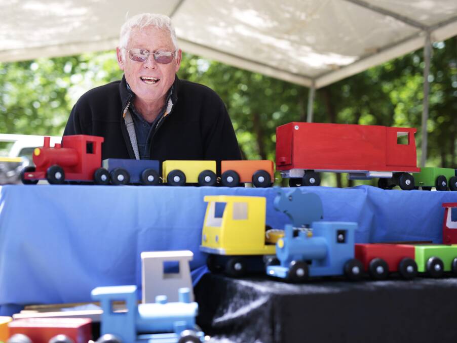 Yesteryear beauties: Bill Coats with his delightful wooden trains. Plenty of shoppers used Springfest as an ideal Christmas shopping locale. Picture: Luka Kauzlaric