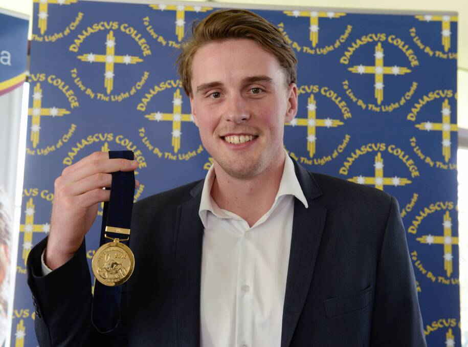 PROUD MOMENT: Western Bulldogs player Jordan Roughead shows off his premiership medal during a trip back to Damascus College on Wednesday. Picture: Kate Healy