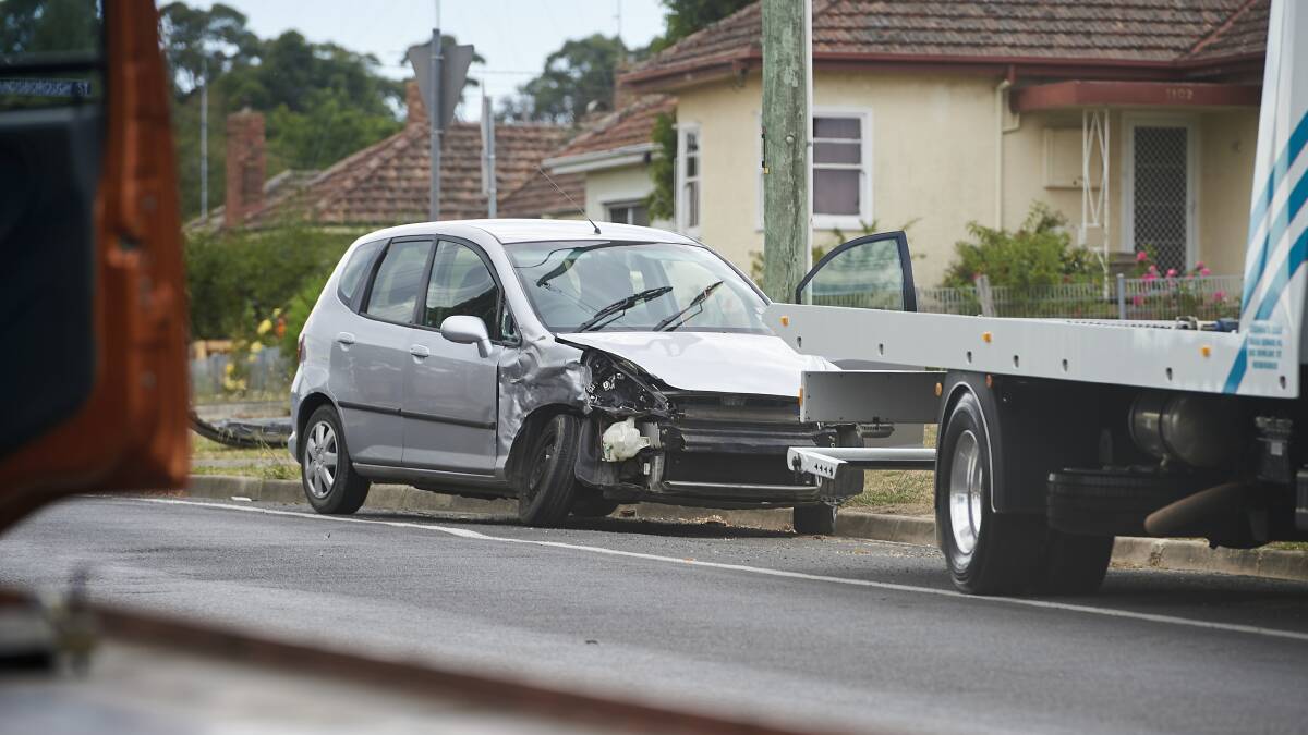DAMAGED: A silver hatchback waits to be towed away from the scene.