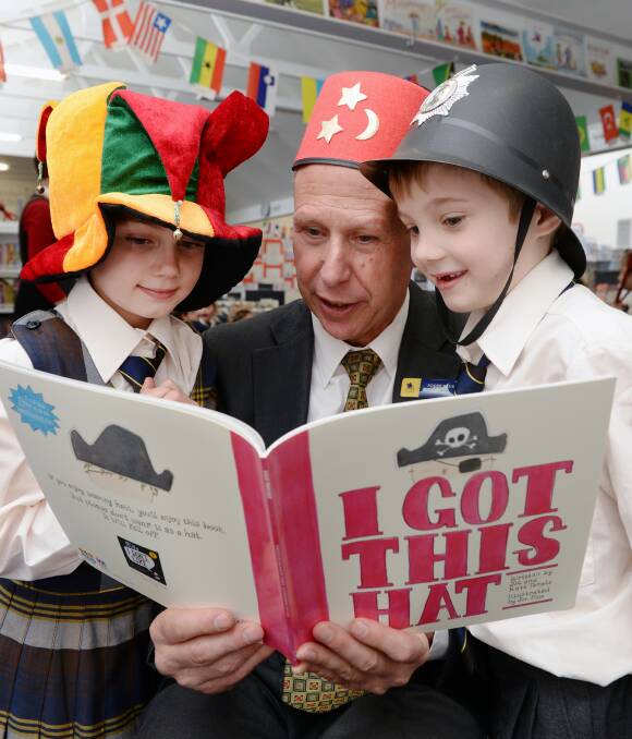 ENGROSSED: Ballarat Grammar School junior school head Roger Bade reads I Got This Hat to prep pupils Emmy and Patrick. Picture: Kate Healy