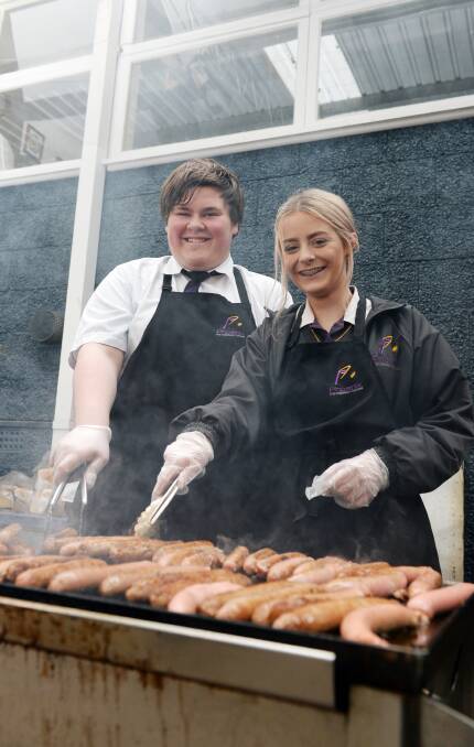 FIRING UP: Phoenix P-12 Community College Phoenix Connect representatives Rohan Delemontex and Shania Keegan help raise funds for the Soup Bus. Picture: Kate Healy