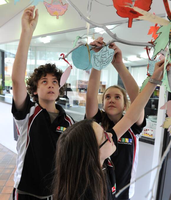 GRATEFUL: Mount Clear College year seven students Miles Simshaw, Charlotte Edgington and Bridget Dyer hang letters to special people as part of their Resilience Day. Picture: Lachlan Bence