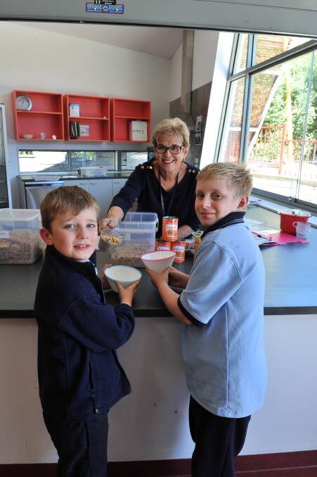 HEALTHY START: Preparing for Mt Pleasant Primary School's weekly Breakfast Club are coordinator Maureen Vallance and students Oliver and Thomas. Picture: Lachlan Bence