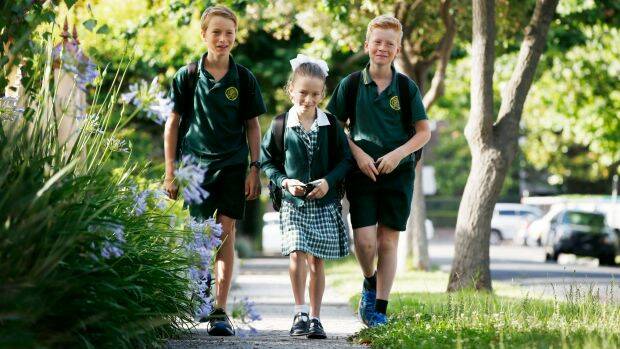 Henry, 11, Annabel, 8, and Tom Feeney, 10, walk to school by themselves. Photo: Darrian Traynor
