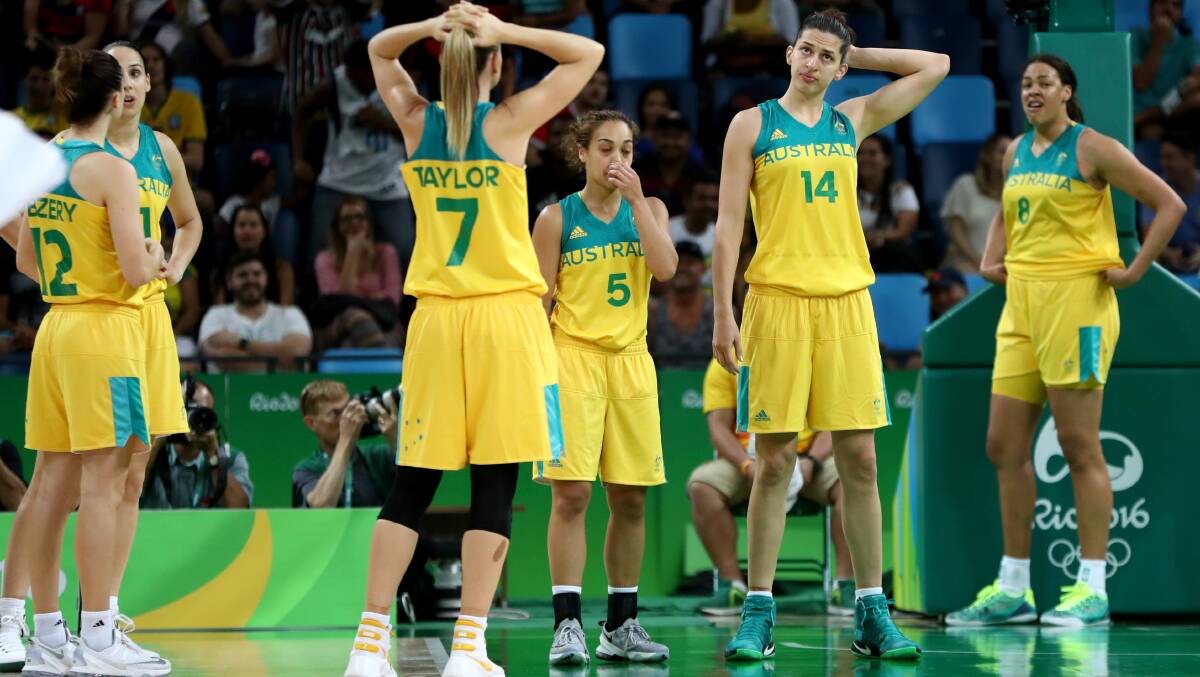 Australia stand dejected after their quarter-final loss. Photo: Phil Walter/Getty Images
