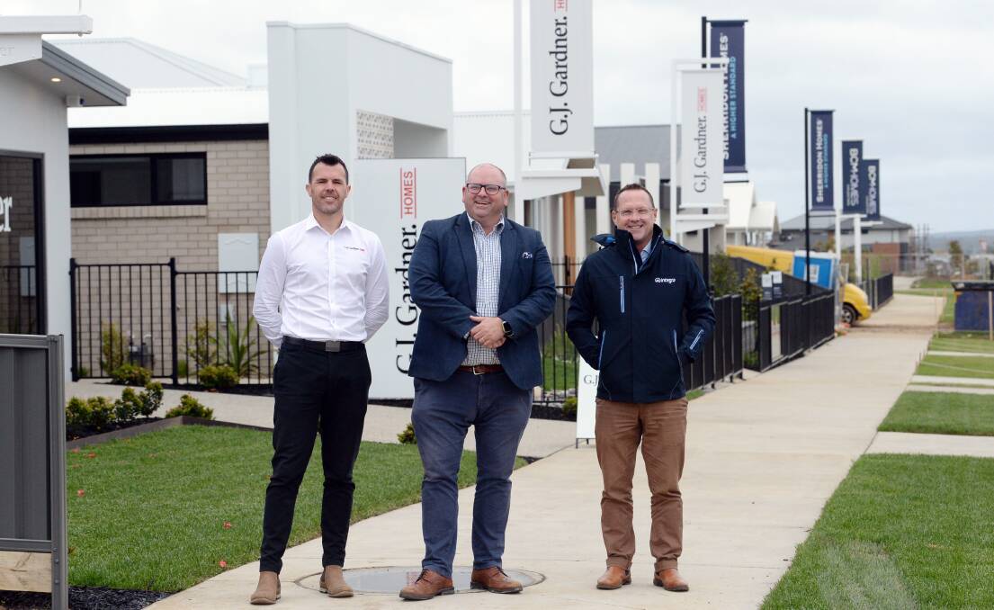 From left, GJ Gardner Homes co-owner Nathan Cavanagh, Metricon regional west sales manager Darren Brennan, Integra sales manager Jamie Gepp at the Lucas display village. Picture by Kate Healy