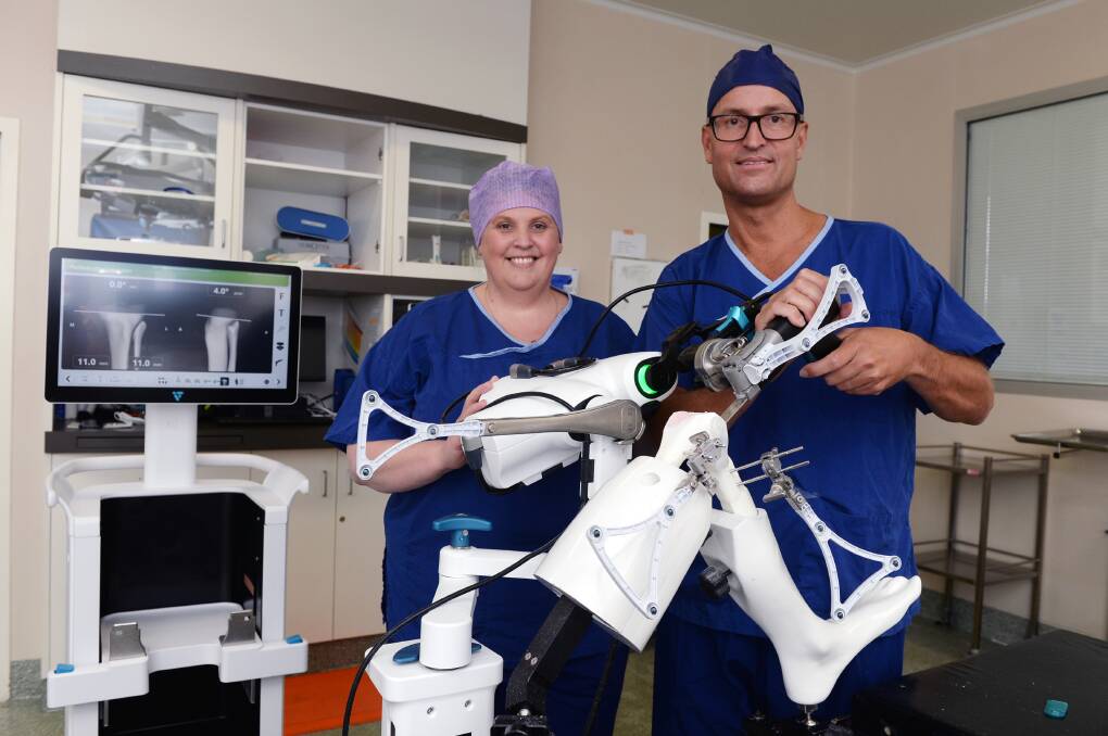 St John of God Ballarat Hospital perioperative manager Jacque Greenwood, left, and orthopaedic surgeon Paul Plank demonstrate the new robotic-assisted device. Picture by Kate Healy