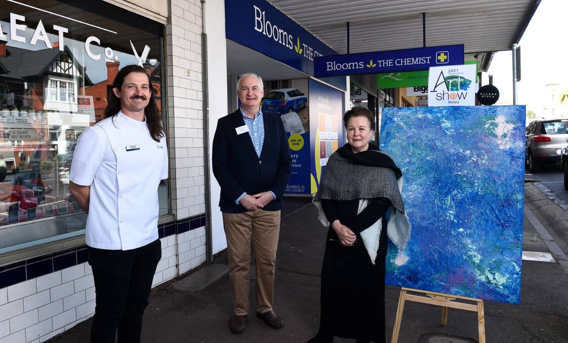 ART SHOW: From left, Blooms the Chemist owner Andrew Leslie, Rotary Club of Daylesford member Tim Cansfield-Smith and artist Roberta Donnelly. Picture: Adam Trafford