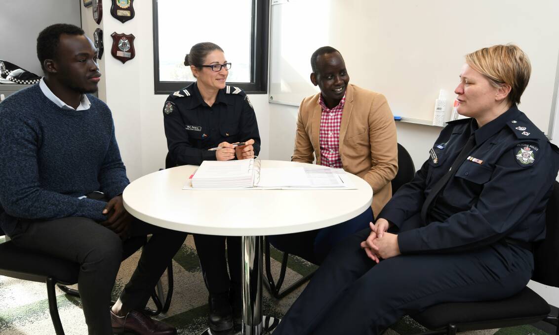 PROGRESS: Mowing Bayn, Leading Senior Constable Mel Peters, Ballarat African Association president Isaac Moses and Superintendent Jenny Wilson discuss the success of the community forums. Picture: Lachlan Bence
