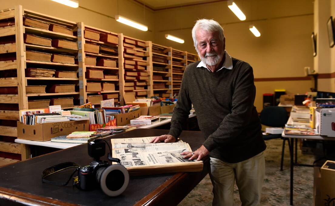 Ballarat photographer Max Harris looks for advertisements in a 1960s edition of The Courier to include in his new book, Ballarat the Swingin 60's. Picture by Adam Trafford 