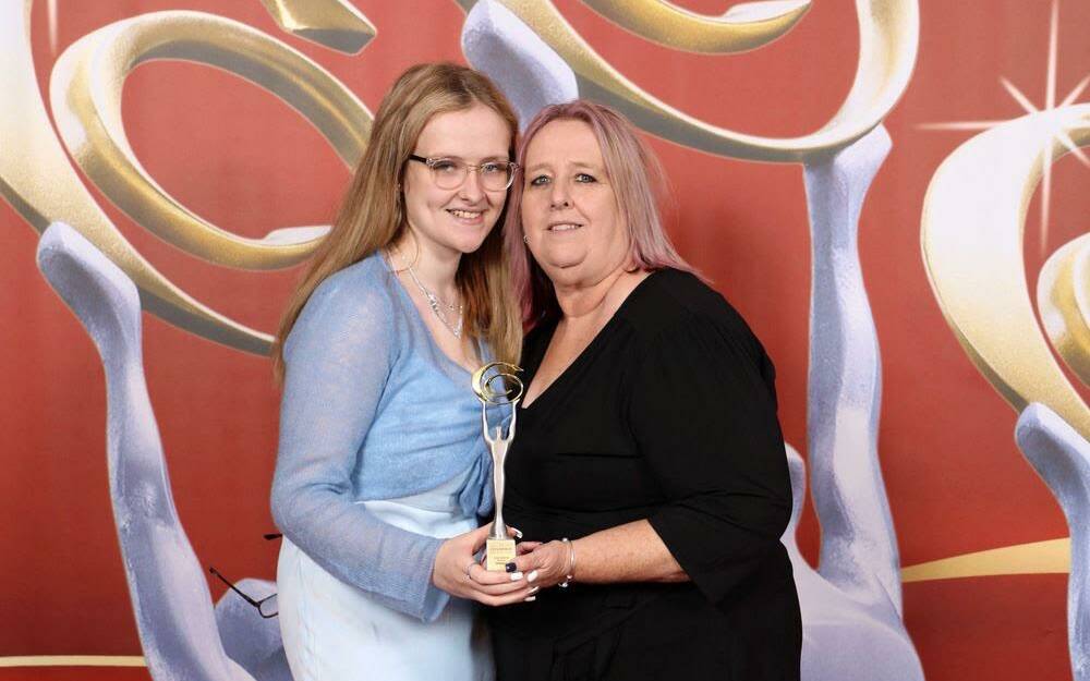 Keeley Johnson and her mother Sharon Murphy receive the award statuette in Sydney after being named Champion Social Enterprise Business. Picture supplied 