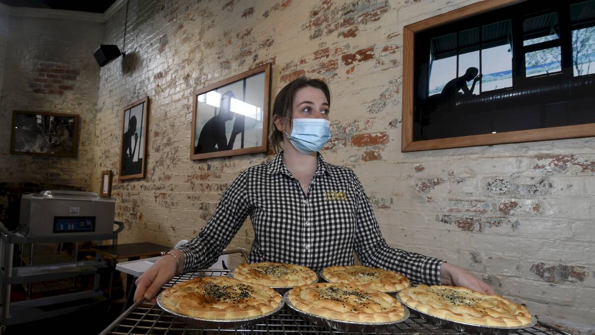 FASCINATING: 1816 Bakehouse manager Michaela Beggs stands beside David Mac Phail's exhibition. Picture: Lachlan Bence
