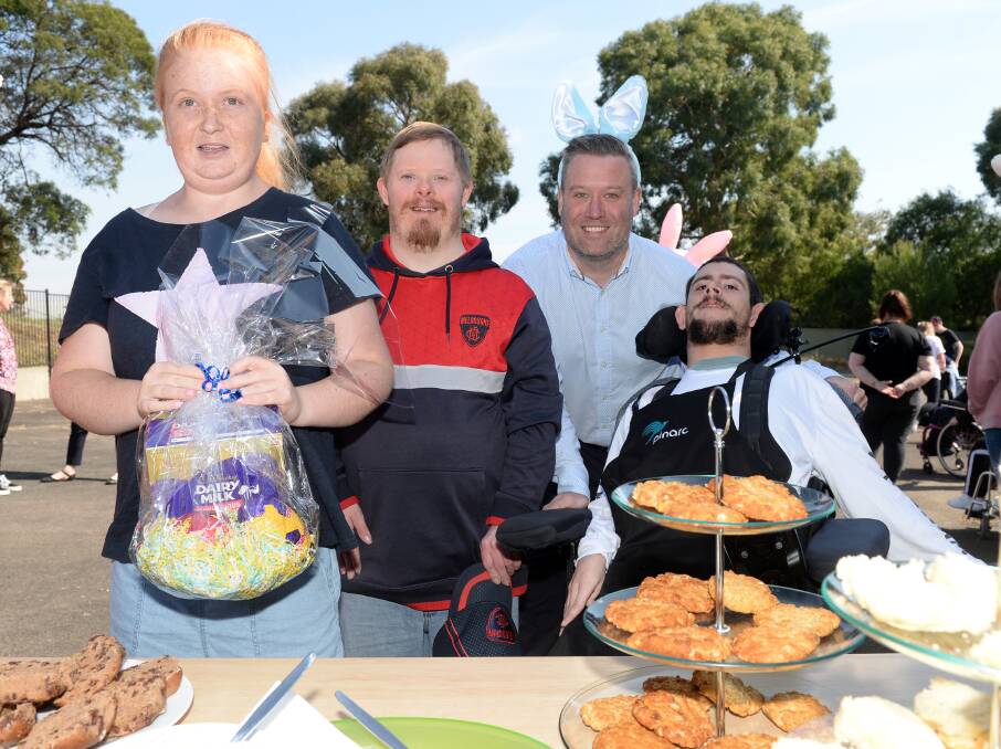 Grace, David, Pinarc Disability Support chief executive Peter Newsome and Lucas celebrate Easter on Wednesday. Pinarc's My Voice group organised the event at its Golden Point campus. Picture by Kate Healy
