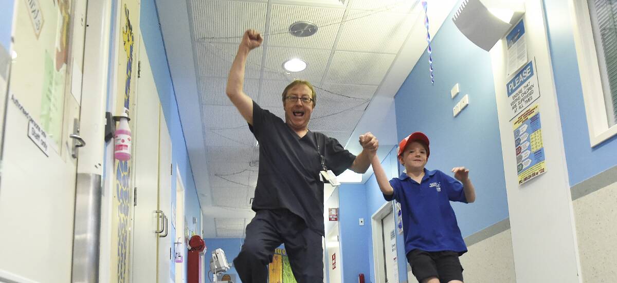 RECOVERING: Hunter Martin, 8, with BHS registered nurse Paul Stanley. Picture: Lachlan Bence 