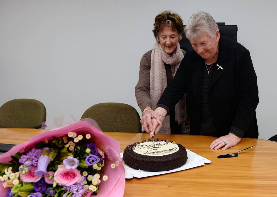 ANNIVERSARY: Court Network volunteer Cheryl Wilde and founder Carmel Benjamin cut the cake. PICTURE: Kate Healy
