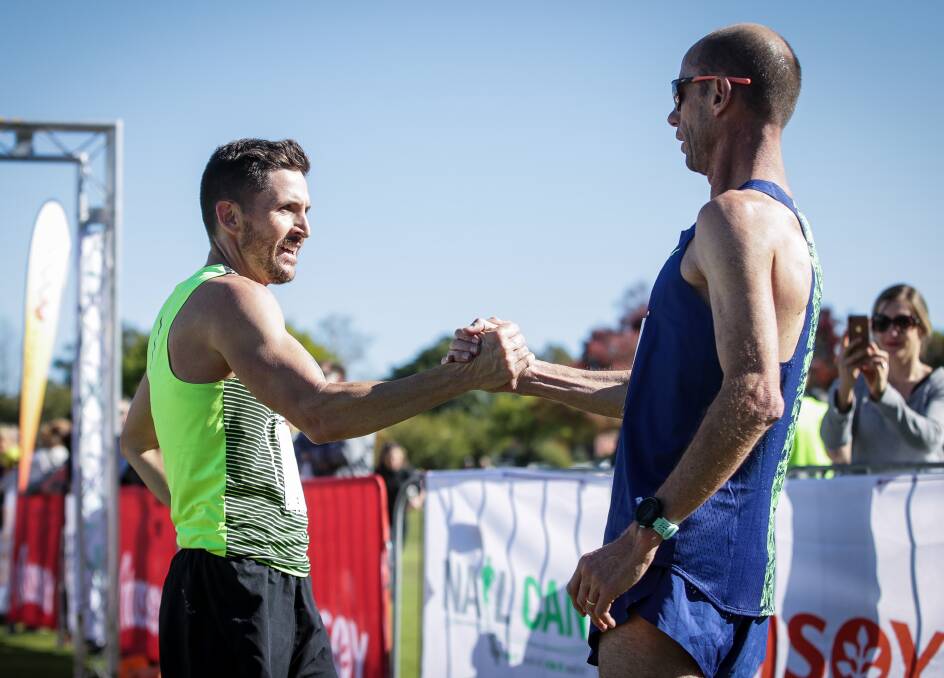 SPORTSMANSHIP: Second placed Ash Hoffmann and Steve Moneghetti shake hands after the race.