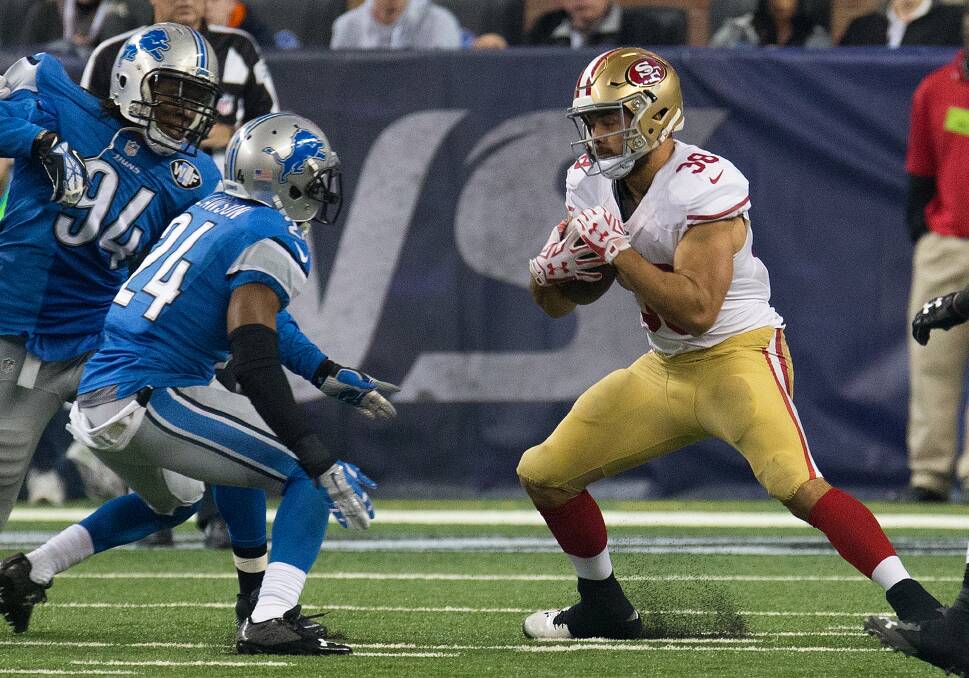 INTERVENTION: Jarryd Hayne of the San Francisco 49ers carries the ball in the second quarter while being blocked by Nevin Lawson of the Detroit Lions during an NFL game  in Detroit last December. (Photo by Dave Reginek/Getty Images)