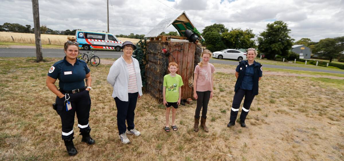 Brightening spirits: Jess McClure, Janine Davis, Lachie Lewis, Nessa Lewis and Mia Dempsey check out the 'Aussie Dunny' hay bale. Picture: Anthony Brady