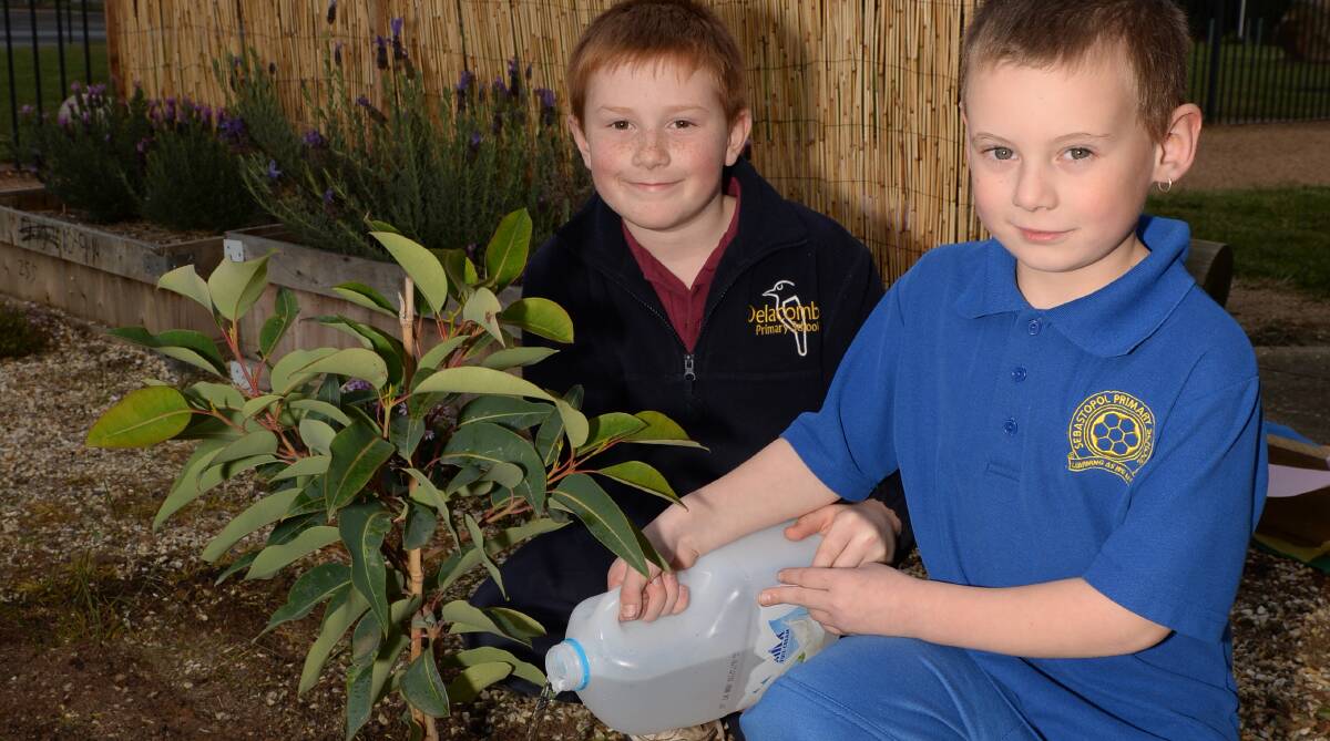 Sensory treat: Delacombe Primary School pupil Jack Clancy, 8, and Sebastopol Primary School’s Connor McPhee, 7, water the garden. Picture: Kate Healy 