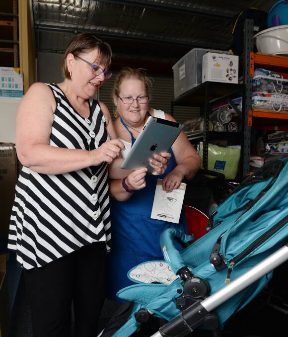 TOP GONG: Eureka Mums Di Campbell and Carlee Kerr use the Canvas app to check products. Representatives will accept an international award in Washington this month. Picture: Kate Healy 