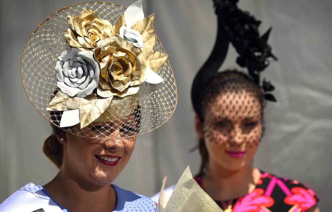 FLORAL BEAUTY: Millinery Award winner Jasmin Fitzgerald and runner-up Nicole Walter in the Myer Fashions on the Field at the 2015 Ballarat Cup. Picture: Luka Kauzlaric