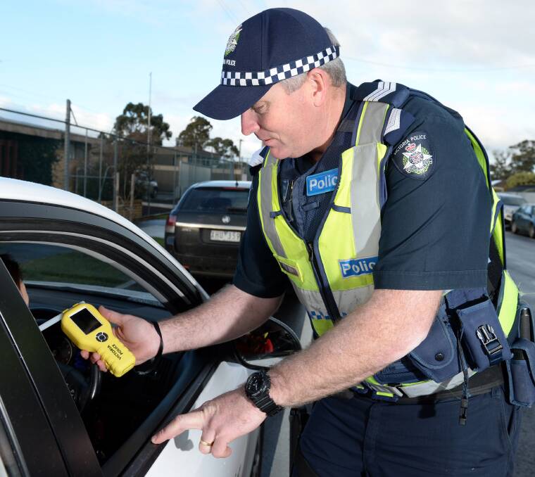 OUT IN FORCE: Sergeant Ben Young conducts a random breath test. Picture: Kate Healy 