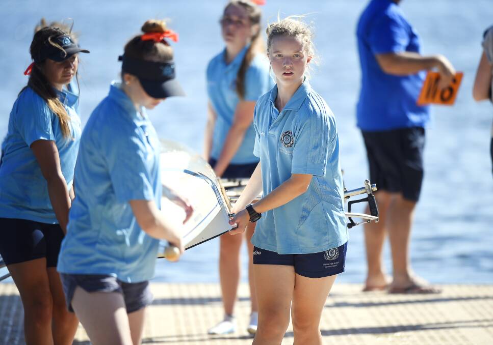 HELPING: Ballarat High School year 10 student Holly Ampt carries her crew's boat during the weekend's Wendouree Ballarat Regatta.