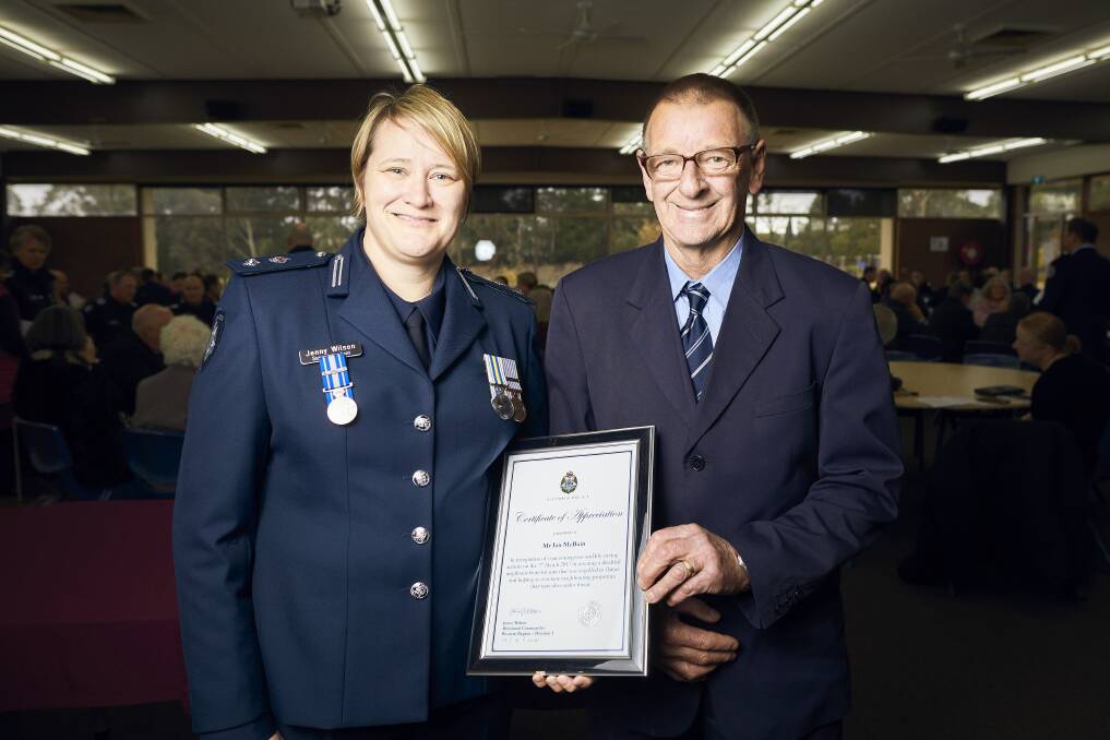 UNSUNG HERO: Superintendent Jenny Wilson awards Ian McBain with a certificate for his bravery in Ballarat this week. Picture: Luka Kauzlaric