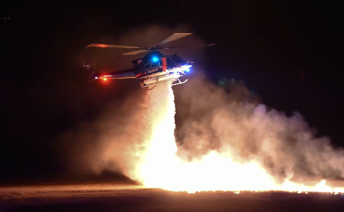 A helicopter bombs a controlled fire in Ballarat this week. Picture: Emergency Management Victoria