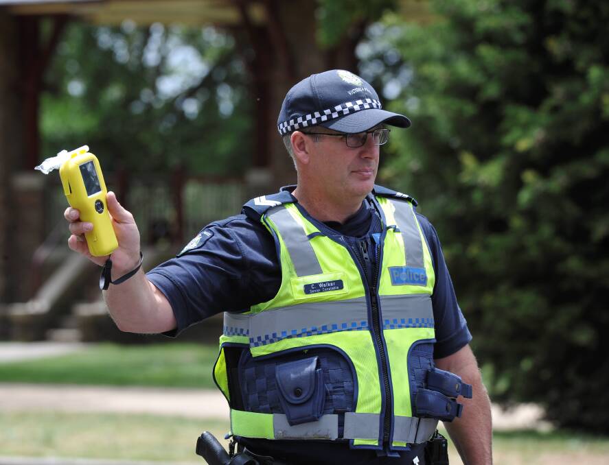 BLITZ: A Ballarat police officer flags down a vehicle for a roadside breath test.