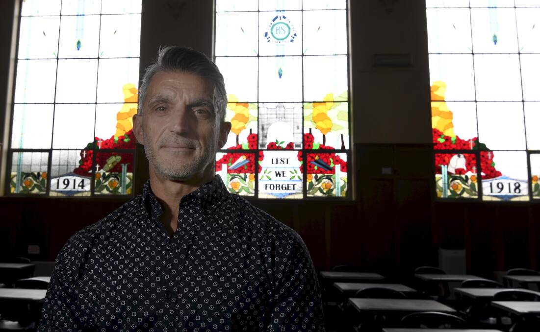 Art teacher Paul Gerardi with Ballarat High School's stained glass windows he helped to create as part of the registered war memorial. Picture by Lachlan Bence