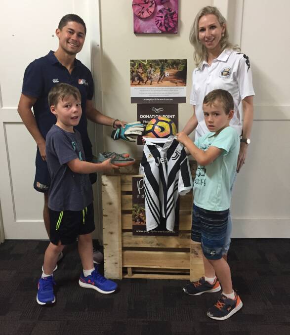 PLAY IT FORWARD: Junior soccer players with Kelly Sports Greater Ballarat manager Dominic Swinton and Ballarat City's Stacey Thomas donate playing gear.