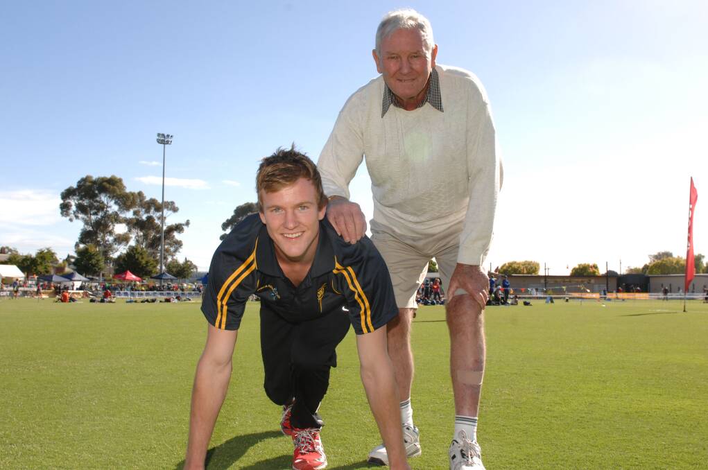 RITUAL: Matt Wiltshire, who won the 2012 Stawell Gift, with his grandfather John Wiltshire, who has missed just one carnival in the past 65 years. 