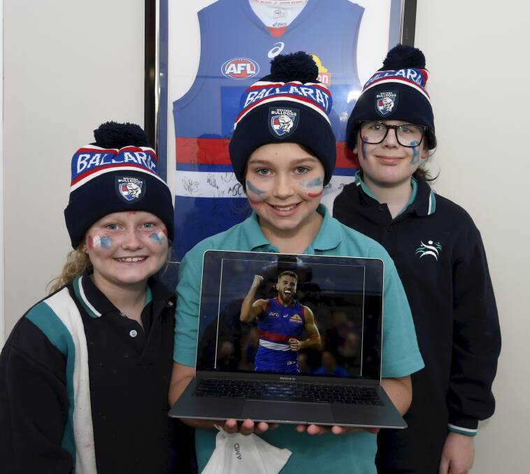 EXCITING: Yuille Park Community College pupils Savannah, Rylee and Onyx get ready to find some page-turners with Western Bulldogs' skipper Marcus Bontempelli. Picture: Lachlan Bence