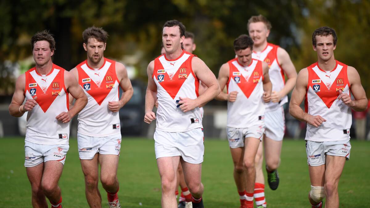 REPRESENT: Ballarat Swans warming up ahead of their own match day. Picture: Adam Trafford