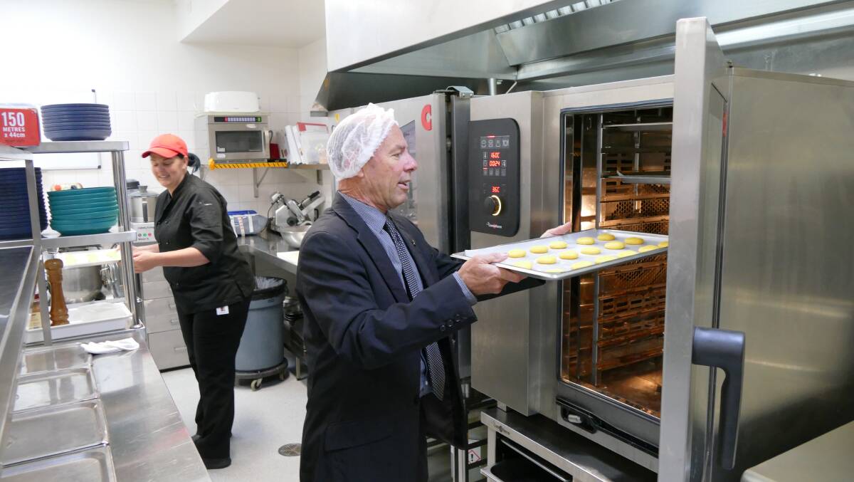 Buninyong MP Geoff Howard offers a hand in Ballan District Health and Care's new kitchen.