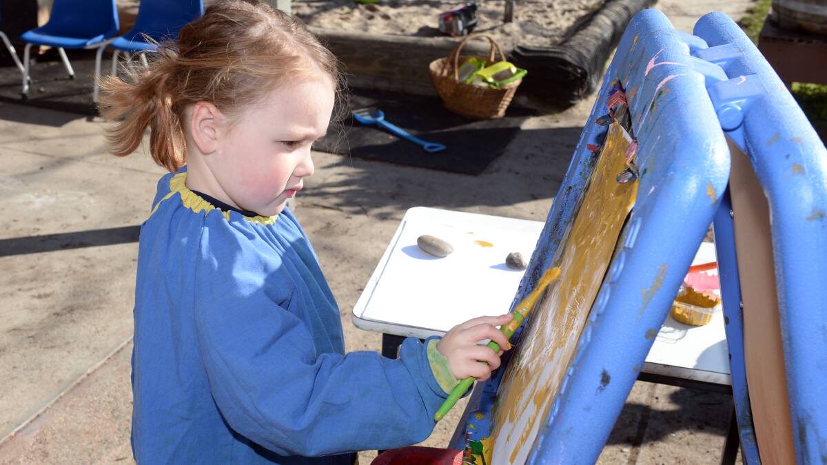 Four-year-old Saydie paints outside at Sebastopol Early Education Centre on Wednesday. Picture: Kate Healy