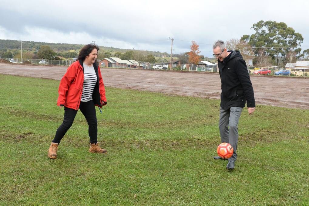LOOKING FORWARD: Buninyong soccer president Sue Mroczkowski has a kick with Ballarat mayor Ben Taylor to kick-off major redevelopment works at Royal Park. Picture: Kate Healy