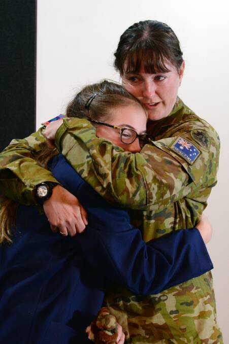 SPECIAL BOND: Corporal Marie Yorston had only expected to be away for a couple of days before fires in Gippsland but she finally got her first day moment with niece Allee. Picture: Kate Healy