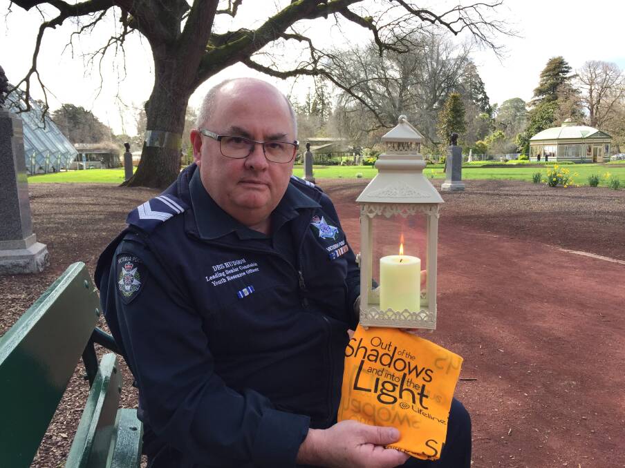 HOPE: Leading Senior Constable Des Hudson lights a path through the gardens each year for people to reflect, find support and look to hope in suicide prevention.