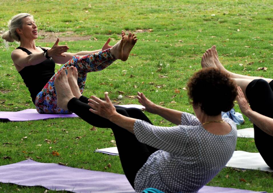 ABOVE: Marian Baird takes Ballarat women in a mindful, lakeside yoga session for World Yoga Day last year.
